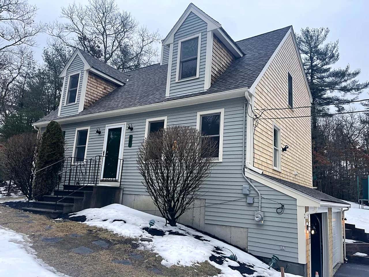 Cape-style house with dormers in winter