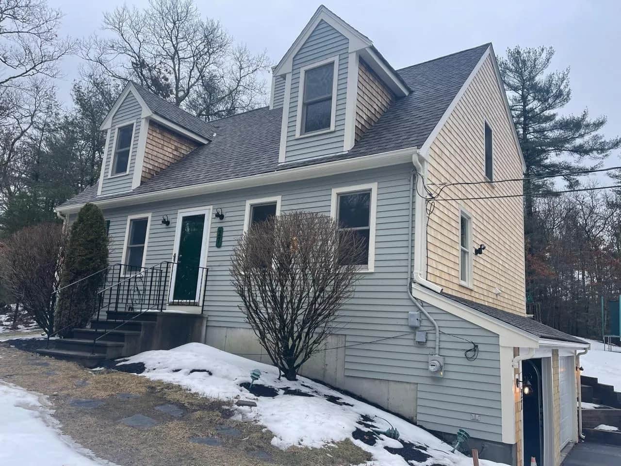 Cape-style house with dormers in winter